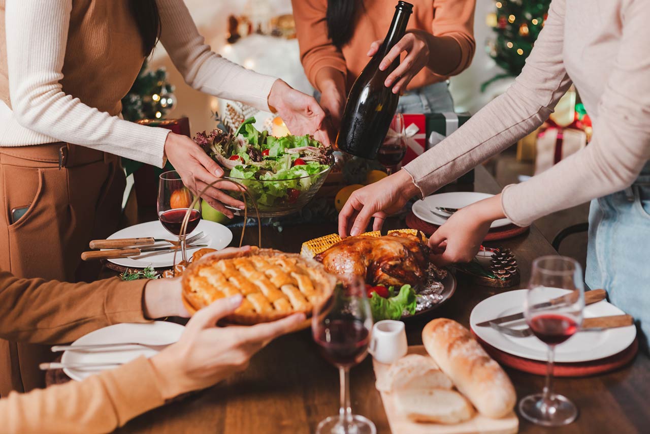 Group of young adult Asian Friends holiday party dinner at home around the table
